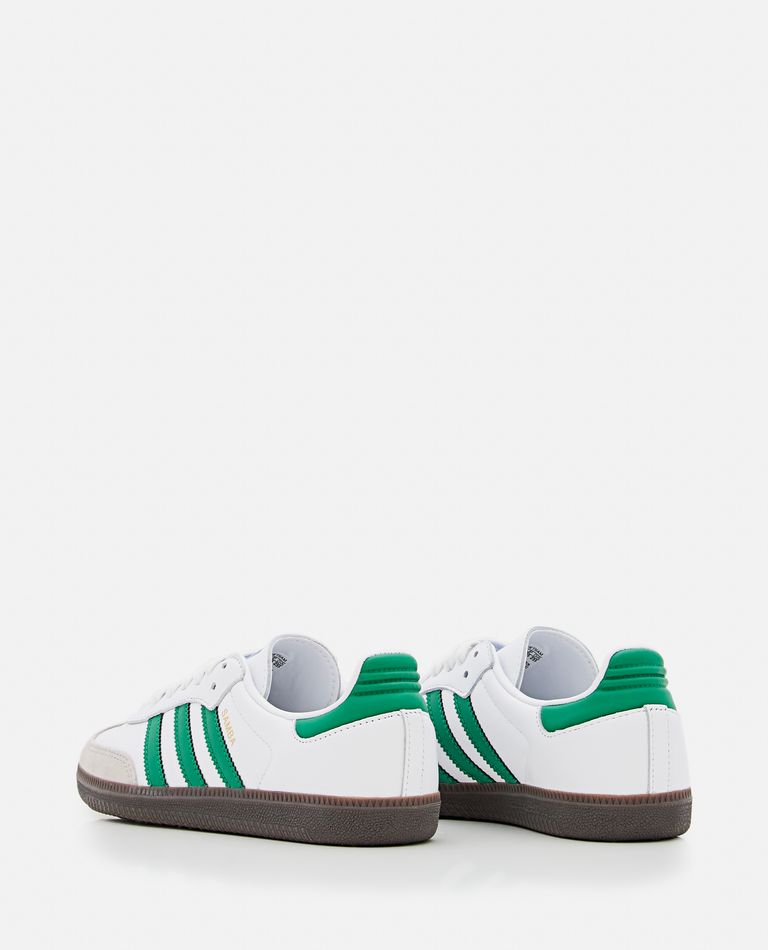 Adidas white shoes with hotsell green stripes